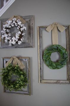 three frames with wreaths hanging on the wall