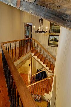 the stairs are made of wood and have wrought iron railings