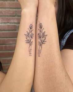 two people with matching tattoos on their arms