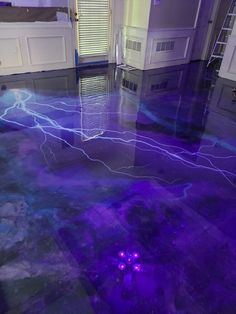 a room that has some purple lights on the floor and it looks like they have been painted