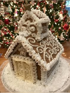 a gingerbread house is decorated with white icing