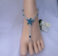 This beautiful pair of barefoot sandal is handmade with a teal blue rhinestones starfish, silver lined seed beads and matching rhinestones. You can wear these for any barefoot activity Foot Jewelry Beach Wedding Blue, Barefoot Sandals Wedding, Blue Starfish, Barefoot Sandal, Sandals Wedding, Foot Jewelry, Jewelry Bridal, Beach Weddings, Wedding Jewellery