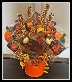 an orange bucket filled with candy and candies