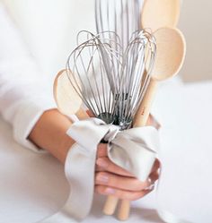 a person holding a bunch of utensils in their hand