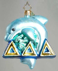 a glass ornament with a dolphin on it's head and triangle shapes