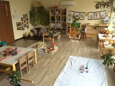 a room filled with lots of wooden furniture and pictures on the wall above it's windows