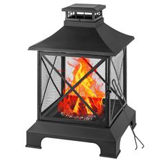 an outdoor fireplace that is lit up and has flames coming out of the top part