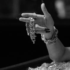 black and white photograph of a woman's hand holding jewelry