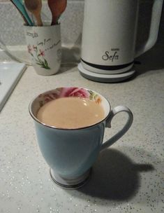 a cup of coffee sitting on top of a counter