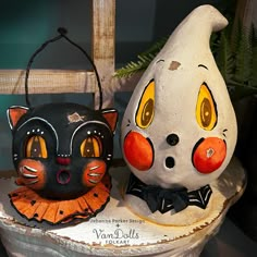 two ceramic cats sitting next to each other