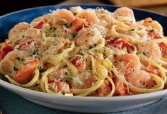 pasta with shrimp and tomato sauce in a blue bowl