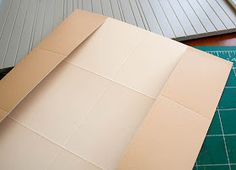 a piece of cardboard sitting on top of a cutting board