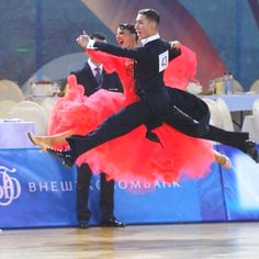 two men in tuxedos are performing a dance on the floor at an event