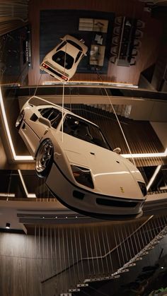 a white sports car suspended from the ceiling