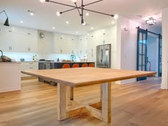 an empty kitchen and dining room with wood flooring