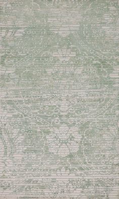 an area rug with green and white designs on it