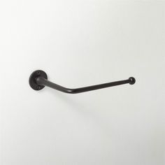 a black towel hook on a white wall