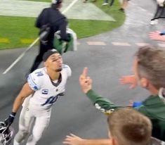 the football player is being greeted by his fans