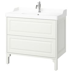 a white bathroom vanity with two drawers and a faucet on one side,