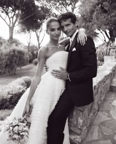 a man and woman are posing for a photo on their wedding day in black and white