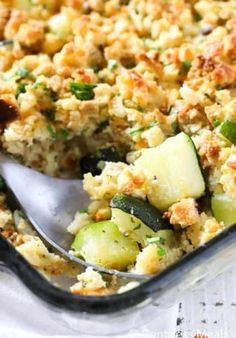 a casserole dish with zucchini, cheese and bread crumbs