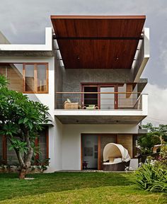 a modern house with an attached deck and covered patio