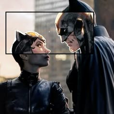 two people dressed as batman and catwoman standing next to each other