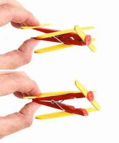 two hands holding small yellow and red toy airplanes on white background with clippings