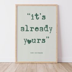 a framed poster with the words it's already yours in green on a white wall