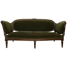 an antique style couch with green velvet upholstered