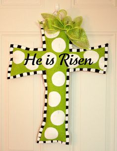 a green and white cross door hanger that says he is risen