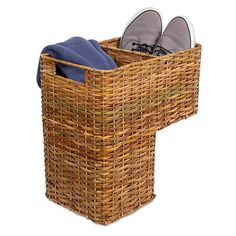 a pair of shoes sitting in a wicker laundry hamper with blue towel and slippers