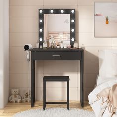 a bedroom with a vanity, mirror and teddy bear on the floor next to it