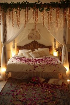 a bed with rose petals on it in a bedroom decorated for valentine's day