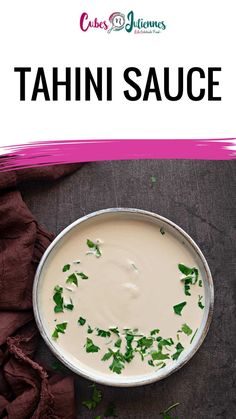 a bowl filled with tahini sauce and garnished with cilantro leaves