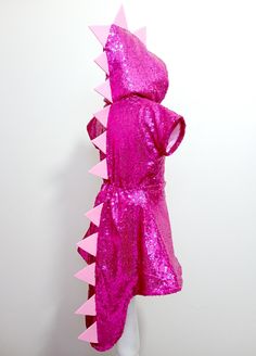 a pink hooded dinosaur costume on a mannequin head