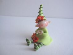 a small figurine sitting on top of a white table