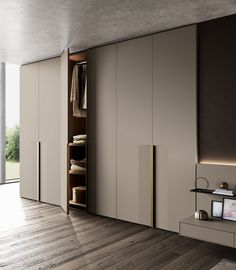 an open closet with clothes hanging on the doors and shelves in front of it, next to a wooden floor