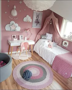 a bedroom with pink walls and wooden flooring is decorated in pastel tones, such as white fluffy clouds