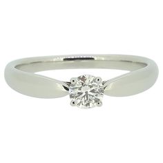 Here we have a beautiful diamond solitaire ring from the world renowned jewellery designer, Tiffany & Co. The centre stone is a charming 0.28 carat round brilliant cut diamond which has been claw set atop Tiffany's iconic graduating band.  Condition: Used (Very Good) Weight: 3.5 grams Band Width: 2.5mm Ring Size: L (52) Diamond Weight: 0.28ct Diamond Details: Colour: I, Clarity – VVS2 Marked: ‘Tiffany & Co.’ ‘PT950’ ‘DO.28’ & Serial Number Documents: Tiffany & Co. Diamond Certificate (paper copy Diamond Solitaire Ring, Jewellery Designer, Tiffany And Co, Diamond Solitaire Rings, Round Brilliant Cut Diamond, Brilliant Cut Diamond, Diamond Solitaire, Solitaire Ring, Tiffany & Co.