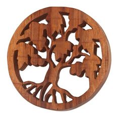 a wooden tree ornament with leaves and branches carved into the shape of a circle