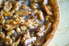 there is a pie with nuts in it on the table