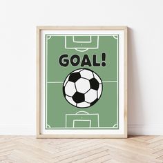 a soccer poster with the words goal in black and white on it, next to a wooden floor