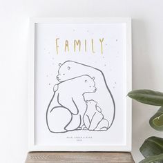 a family bear and her cub print on a shelf next to a potted plant