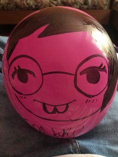 a close up of a ball with a face drawn on it