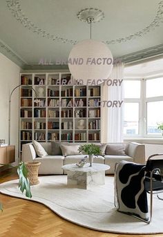 a living room filled with lots of furniture and bookshelves