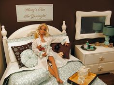 a doll sitting on top of a bed in a room