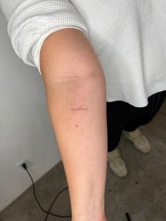 a person with a small tattoo on their arm