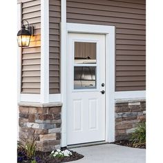 a white door with a glass window in front of a house