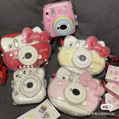 four hello kitty cameras sitting next to each other